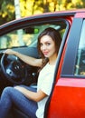 Beautiful young woman driver behind wheel red car Royalty Free Stock Photo