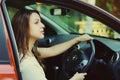 Beautiful young woman driver behind a wheel red car Royalty Free Stock Photo