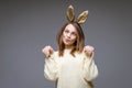 beautiful young woman with ears posing on background