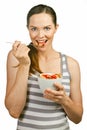 Beautiful young woman eating a bowl of cereal Royalty Free Stock Photo