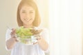 Beautiful young woman eating a bowl of healthy organic salad Royalty Free Stock Photo