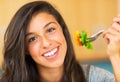 Beautiful young woman eating a bowl of healthy organic salad Royalty Free Stock Photo