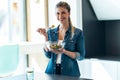 Beautiful young woman eating a bowl of salad in the kitchen at home Royalty Free Stock Photo