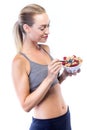 Beautiful young woman eating cereals and fruits over white background. Royalty Free Stock Photo