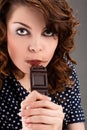Beautiful young woman eating chocolate Royalty Free Stock Photo