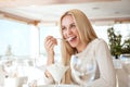 Beautiful young woman eating ice-cream in cafe Royalty Free Stock Photo