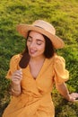 Beautiful young woman eating ice cream glazed in chocolate on green grass outdoors Royalty Free Stock Photo