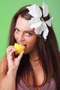 Beautiful young woman eating lemon