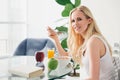 beautiful young woman eating muesli for breakfast and smiling at camera Royalty Free Stock Photo