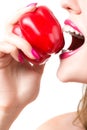Beautiful young woman eating paprika Royalty Free Stock Photo