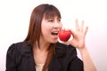 Beautiful young woman eating red apple