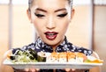 Beautiful young woman eating sushi. Royalty Free Stock Photo