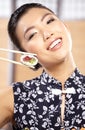 Beautiful young woman eating sushi. Royalty Free Stock Photo