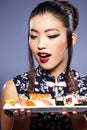 Beautiful young woman eating sushi. Royalty Free Stock Photo