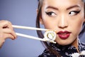 Beautiful young woman eating sushi. Royalty Free Stock Photo