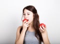 Beautiful young woman eating an vegetables. holding tomatoes. healthy food - strong teeth concept Royalty Free Stock Photo