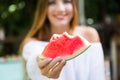 Beautiful young woman eating watermelon in the home garden. Royalty Free Stock Photo