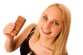 Beautiful young woman eats chocolate isolated over white background