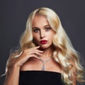 Beautiful young woman with elegant hairstyle and jewelry. Perfect makeup. Blonde girl Royalty Free Stock Photo