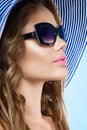 Beautiful young woman in elegant hat and sunglasses Royalty Free Stock Photo