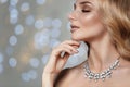 Beautiful young woman with elegant jewelry against defocused lights Royalty Free Stock Photo