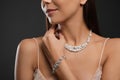 Beautiful young woman with elegant jewelry on dark background Royalty Free Stock Photo
