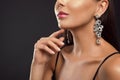 Beautiful young woman with elegant jewelry on dark background, closeup. Royalty Free Stock Photo