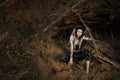 Beautiful young woman with elf ears, dreadlocks and an ethnic poncho, with painted face. Posing against a sandy career Royalty Free Stock Photo