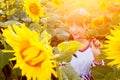 Beautiful young woman in embrodery on a sunflower field Royalty Free Stock Photo