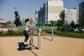 A beautiful young woman is engaged in sports on a street simulator. Concept of good physical shape and healthy lifestyle Royalty Free Stock Photo