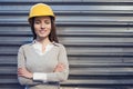 A beautiful young woman engineer is in front of a construction crane wearing protective gear, helmet and glasses. Royalty Free Stock Photo