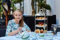 Beautiful young woman enjoying afternoon tea Royalty Free Stock Photo