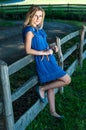 Beautiful young woman enjoying countryside view with green pastures