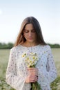 Beautiful young woman enjoying a field of daisies, beautiful girl relaxing outdoors, having fun Royalty Free Stock Photo