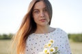 Beautiful young woman enjoying a field of daisies, beautiful girl relaxing outdoors, having fun Royalty Free Stock Photo