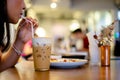 Beautiful young woman enjoying latte coffee in cafe, Woman sucks ice coffee with milk