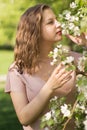 Beautiful young woman enjoying nature in the spring apple orchard, happy Beautiful girl in the garden with flowering Royalty Free Stock Photo