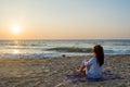 Beautiful young woman enjoying sunset on the beach Royalty Free Stock Photo