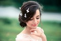 Beautiful young woman enjoys a spring day. Creative hairstyle with butterflies in your hair Royalty Free Stock Photo