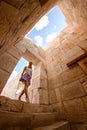 beautiful young woman enters building ruins of ancient Lycian city Patara. Royalty Free Stock Photo