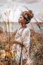 Beautiful young woman in ethnic dress on a field close up portrait