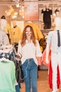 Beautiful young woman exits or walks at fashion and clothes Shop Royalty Free Stock Photo