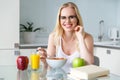 beautiful young woman in eyeglasses eating breakfast and smiling Royalty Free Stock Photo