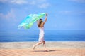 Beautiful young woman with fabric running on quay Royalty Free Stock Photo