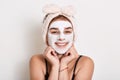 Beautiful young woman with facial mask on her face, doing skin care and treatment procedures, natural beauty and cosmetology, Royalty Free Stock Photo