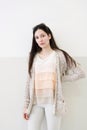 Beautiful young woman in fashinable knitted beige cardigan sta Royalty Free Stock Photo