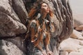 Beautiful young woman with feathers in hairoutdoors portrait