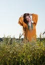 Beautiful young woman in a field. Model runs her hands through her hair Royalty Free Stock Photo