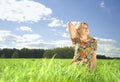 Beautiful young woman on field in summer time Royalty Free Stock Photo