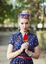 Beautiful young woman in fifties style with candy